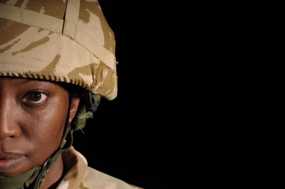 woman in military garb looks at camera