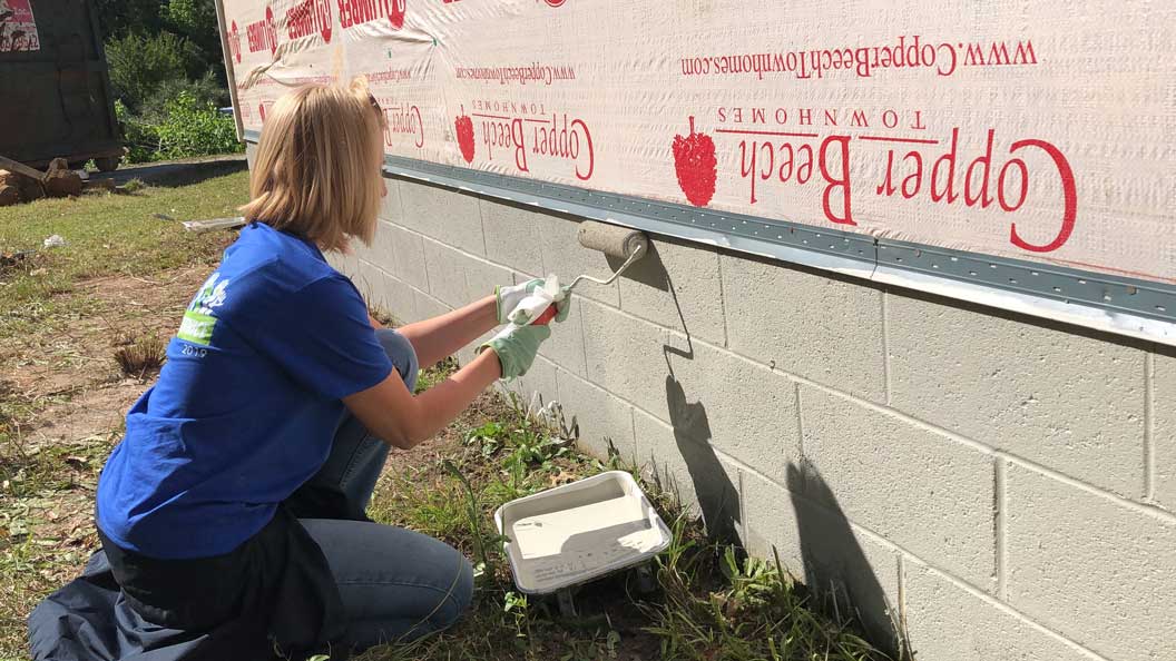 woman painting a house