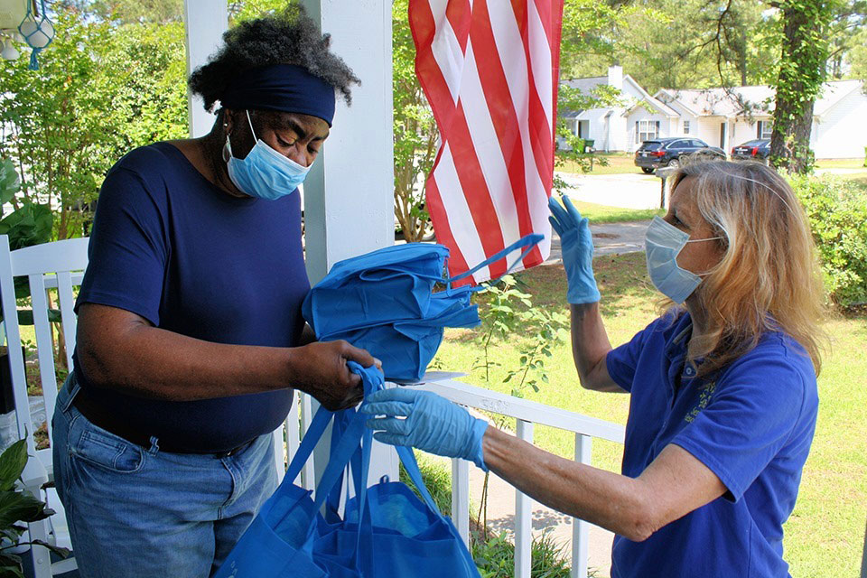 Senior Resources volunteer delivers meal to senior citizen