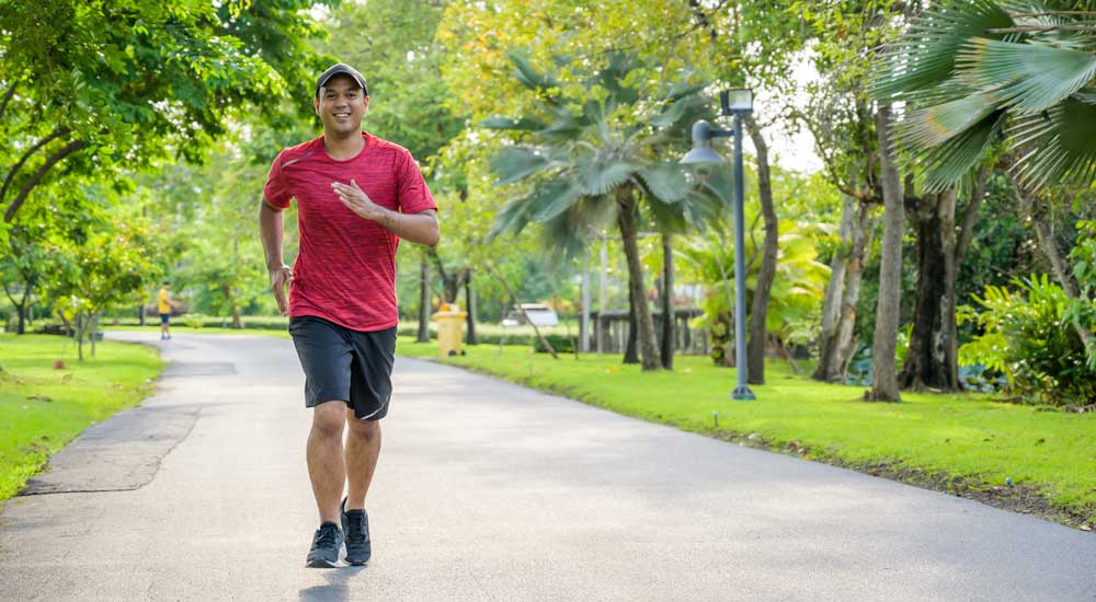 man running outside in park