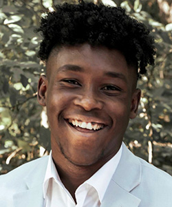 Quentin Whitfield, a young male student at Claflin University, smiles into the camera.