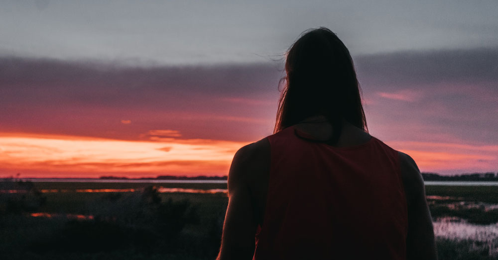 woman walking at sunset