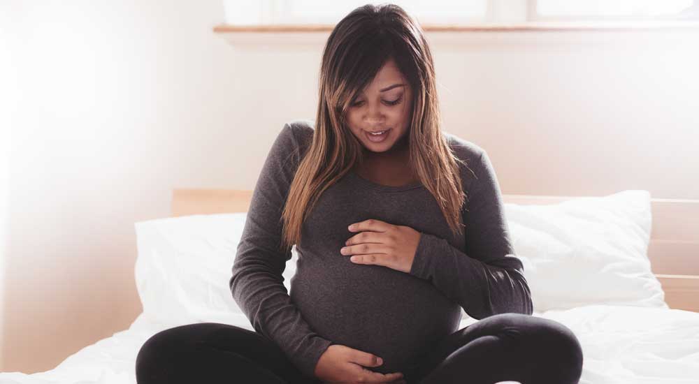 pregnant woman holding her belly