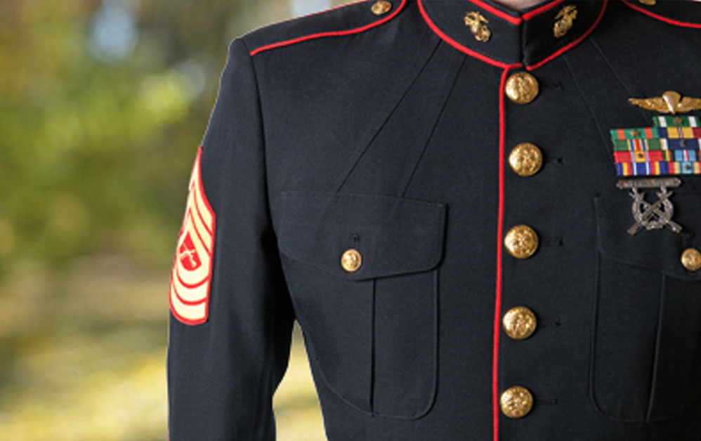 close up of military suit with gold buttons and colorful ribbons