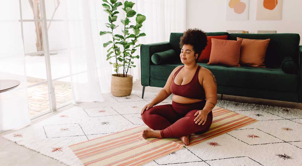 woman sitting on yoga mat 