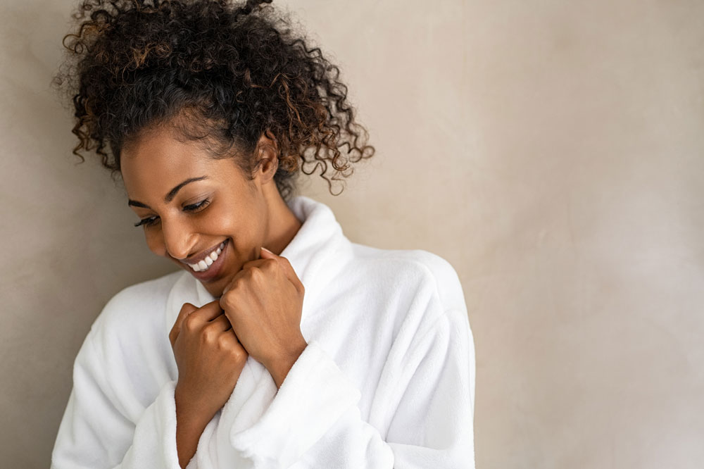 smiling woman wearing a white robe