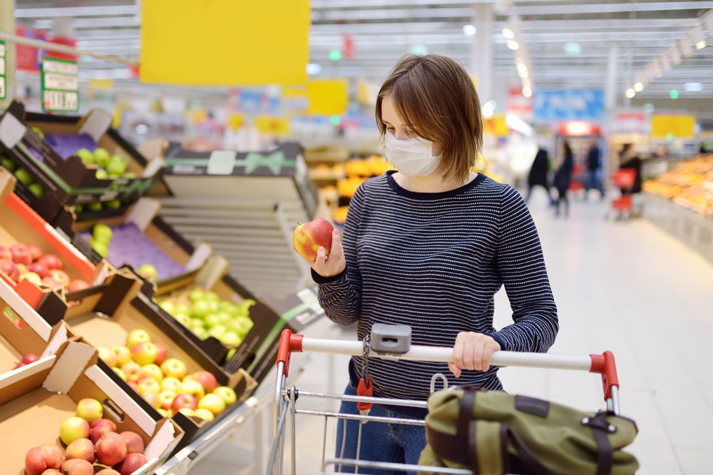 woman shops with mask on