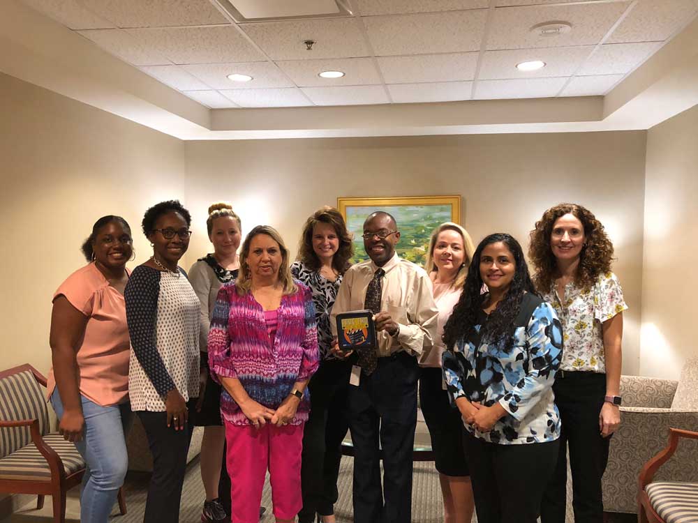 Group of diverse BlueCross employees smiling