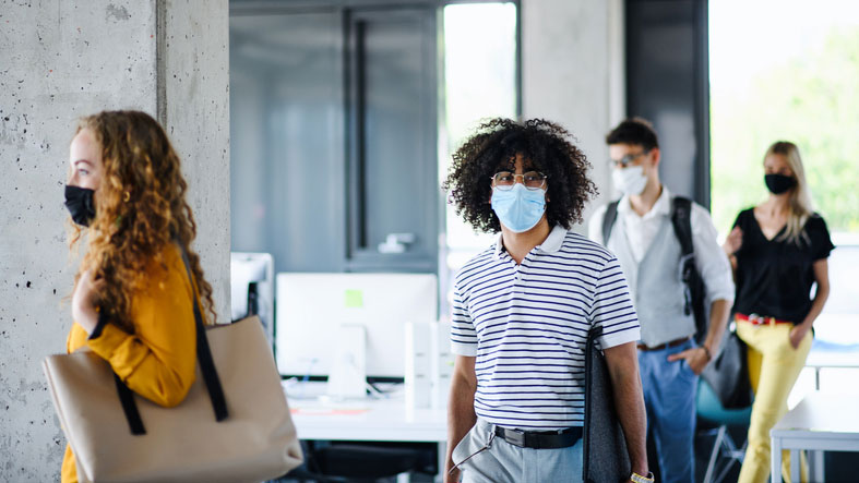 Interns enter office building wearing masks