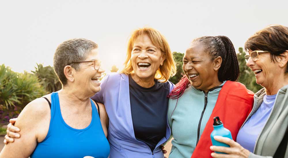 group of older woman laughing outside